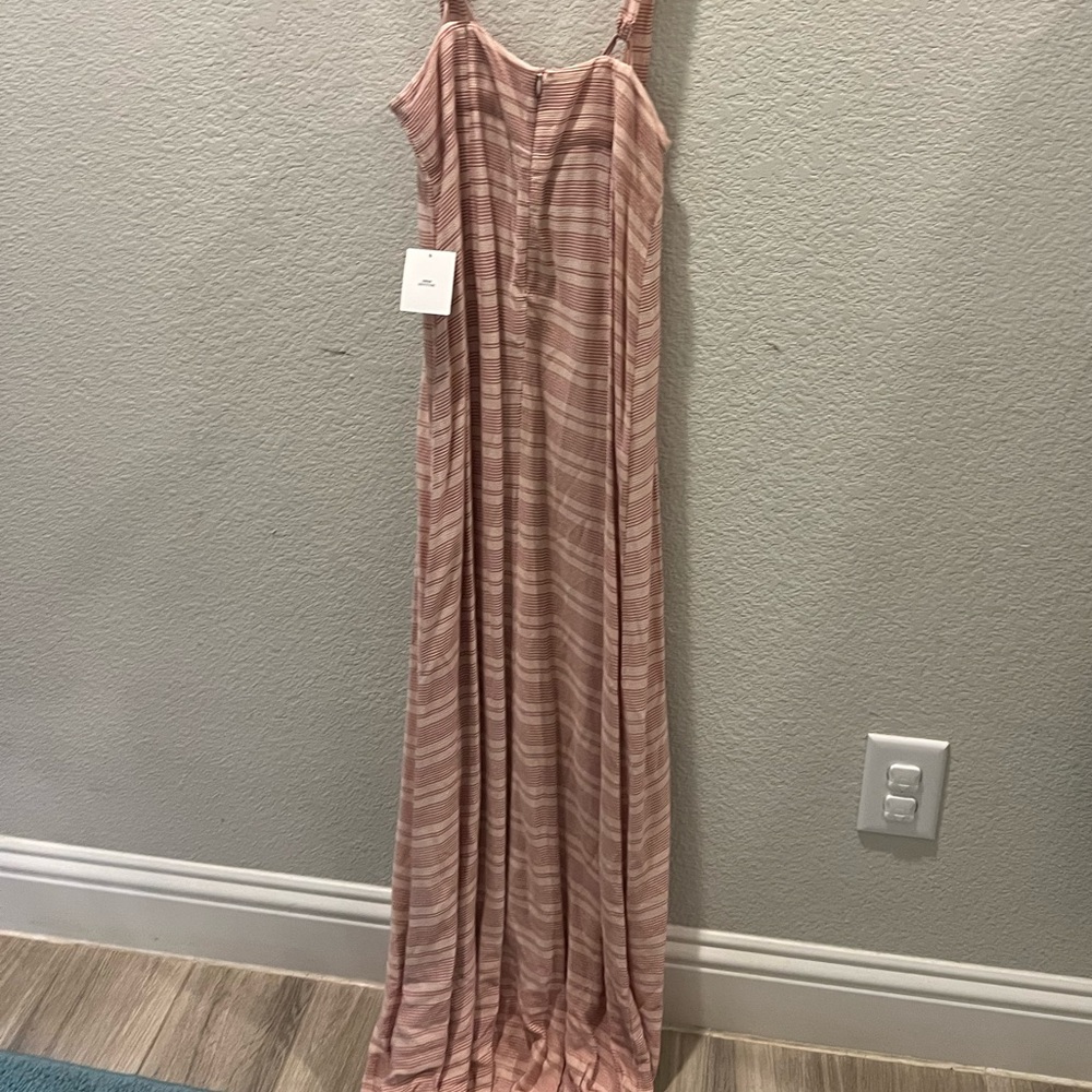 A long dress/jumper meant to be worn with a white or top underneath.